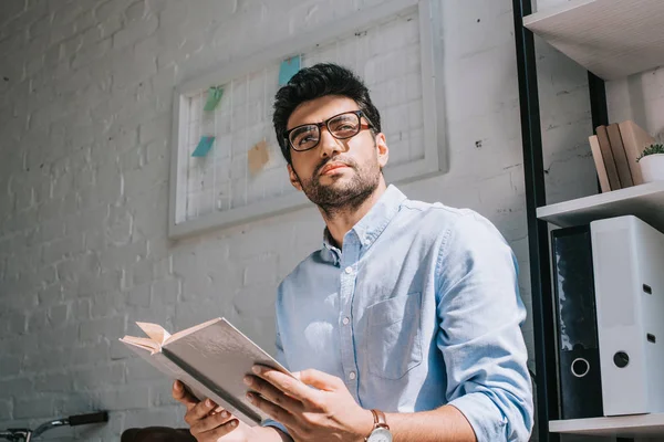 Handsome Architect Glasses Holding Book Looking Away Office — Stock Photo, Image