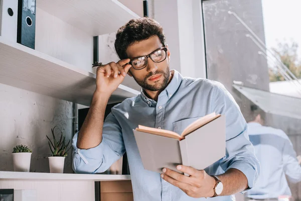 Handsome Architect Touching Glasses Reading Book Office — Stock Photo, Image