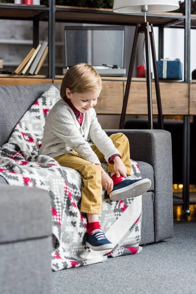 Cute Happy Child Sitting Couch Putting Shoe — Stock Photo, Image