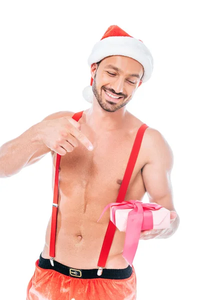 Smiling Shirtless Muscular Man Christmas Hat Pointing Gift Box Isolated — Free Stock Photo