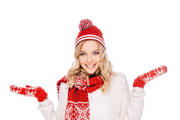 portrait of beautiful young woman in hat, scarf and mittens smiling at camera isolated on white 