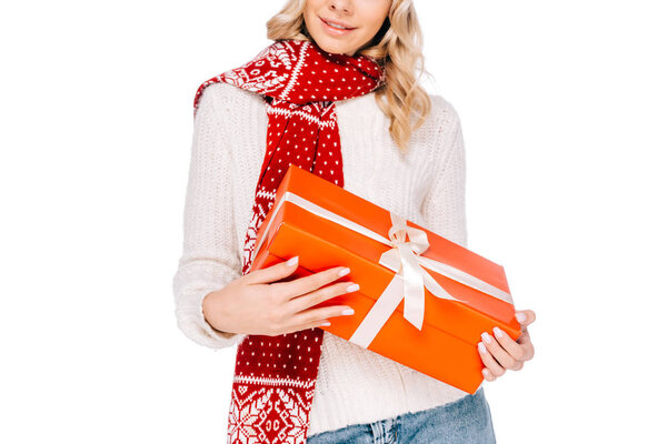 cropped shot of beautiful smiling girl holding gift box isolated on white