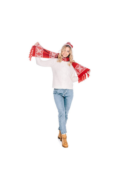 full length view of beautiful happy young woman in scarf and hat smiling at camera isolated on white 