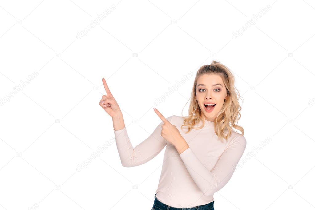 beautiful happy girl pointing up with fingers and smiling at camera isolated on white