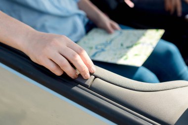 cropped shot of woman holding travel map inside car clipart