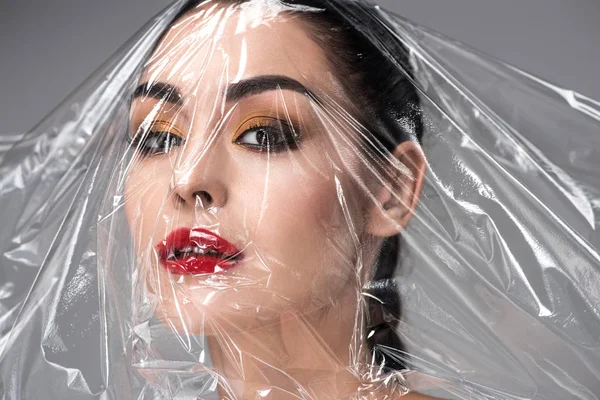 Beautiful Young Woman Transparent Polyethylene Face Looking Camera Grey — Stock Photo, Image