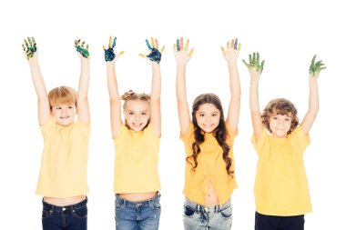 adorable happy kids showing hands in paint and smiling at camera isolated on white clipart