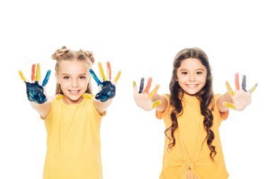 beautiful happy children showing colorful painted hands and smiling at camera isolated on white clipart