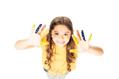 high angle view of adorable child showing colorful painted hands and smiling at camera isolated on white     clipart
