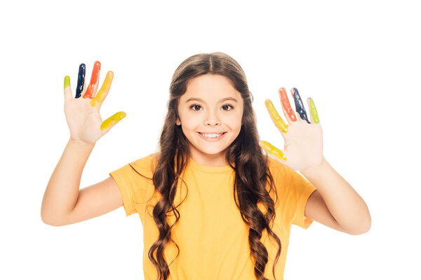 beautiful happy kid showing colorful painted hands and smiling at camera isolated on white  