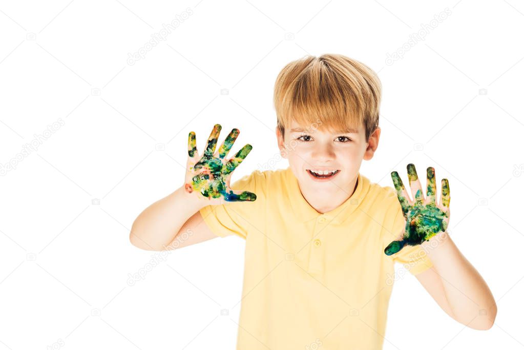 high angle view adorable happy boy with hands in colorful paint smiling at camera isolated on white   