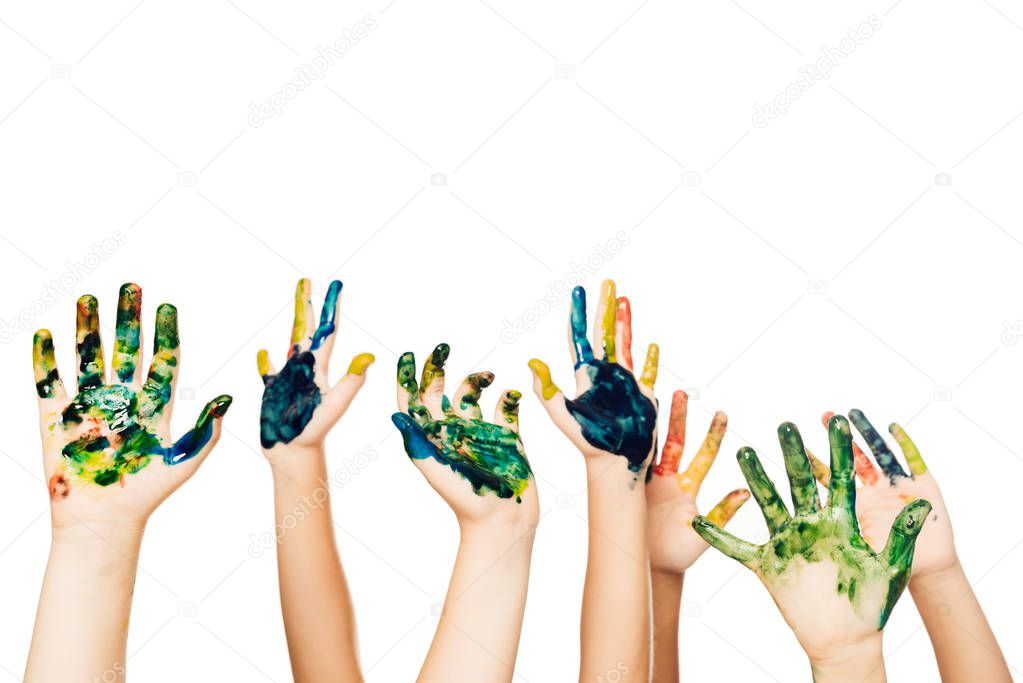 cropped shot of children showing hands in colorful paint isolated on white