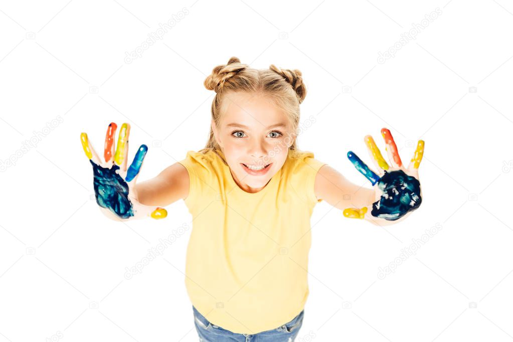 high angle view of beautiful happy child showing colorful painted hands and smiling at camera isolated on white      