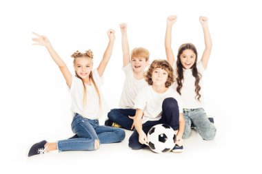eller yükselterek ve üzerinde beyaz izole kamera gülümseyen futbol topu ile mutlu çocuklar