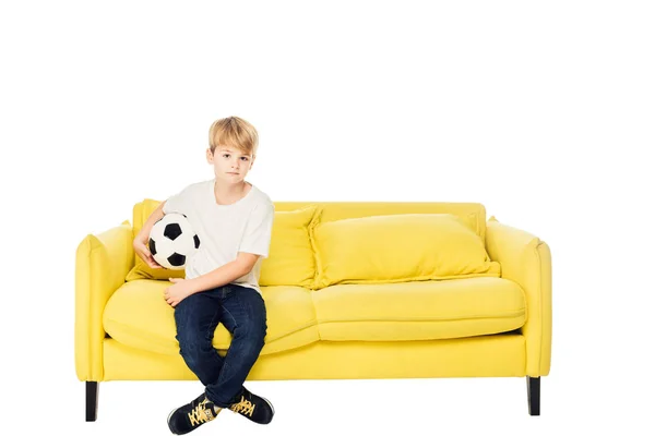 Adorable Boy Sitting Football Ball Yellow Sofa Isolated White Looking — Free Stock Photo