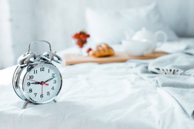 close-up view of alarm clock and tasty breakfast on bed clipart