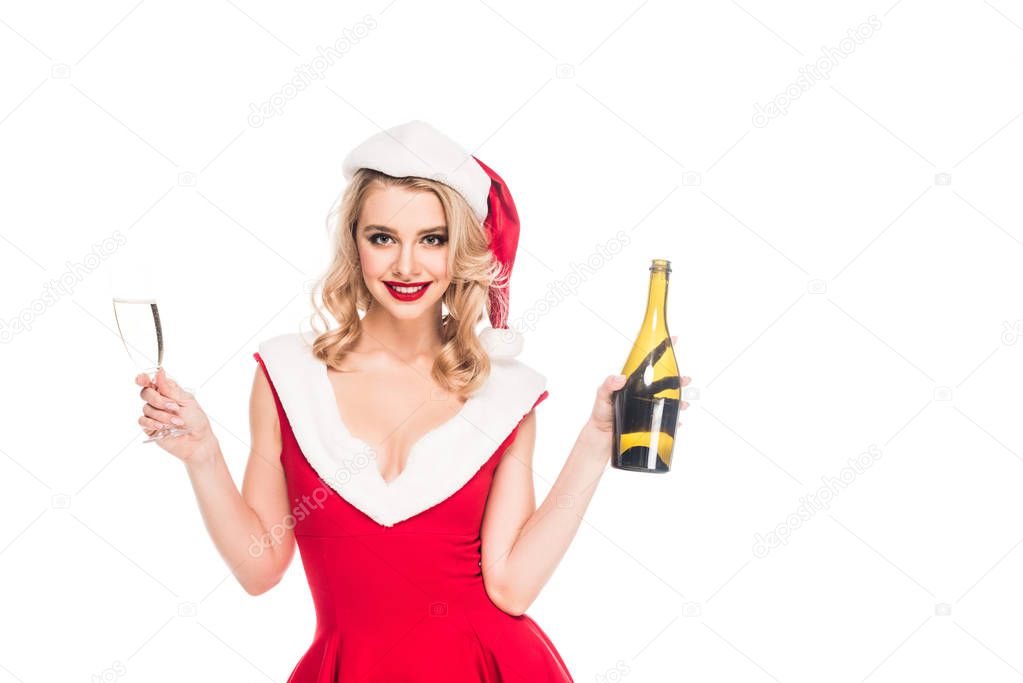 beautiful santa girl in christmas dress celebrating with champagne bottle and glass isolated on white