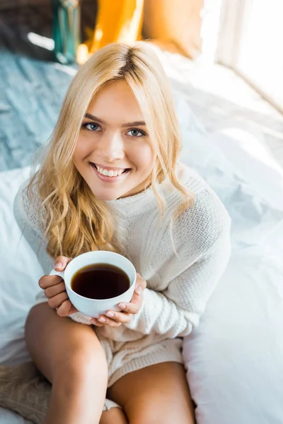 Smiling Attractive Woman Sweater Holding Cup Coffee Looking Camera Bedroom — Stock Photo, Image