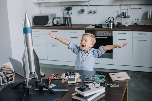 Happy Rozkošný Chlapec Stojí Nataženou Rukou Modelu Rakety Kuchyni Víkend — Stock fotografie