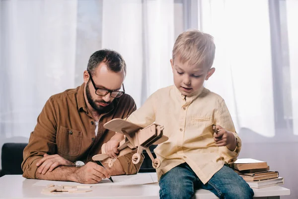 Father Adorable Little Son Modeling Together Home — Free Stock Photo