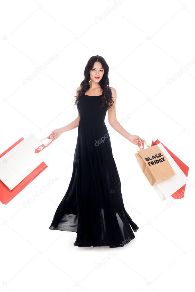 elegant beautiful woman in black dress with shopping bags isolated on white