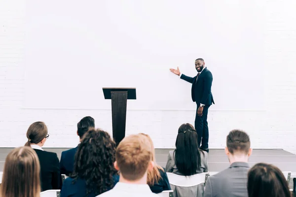 Smiling African American Lecturer Talking Audience Seminar Conference Hall Pointing — Stock Photo, Image