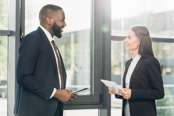 multiracial business colleague discussing lecture in conference hall