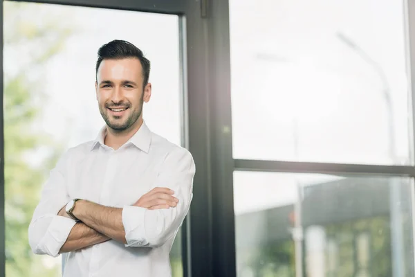 Portrait Smiling Businessman Arms Crossed Standing Conference Hall — Stock Photo, Image