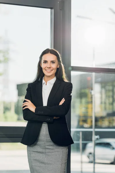 Portrait Smiling Businesswoman Arms Crossed Standing Conference Hall — Stock Photo, Image