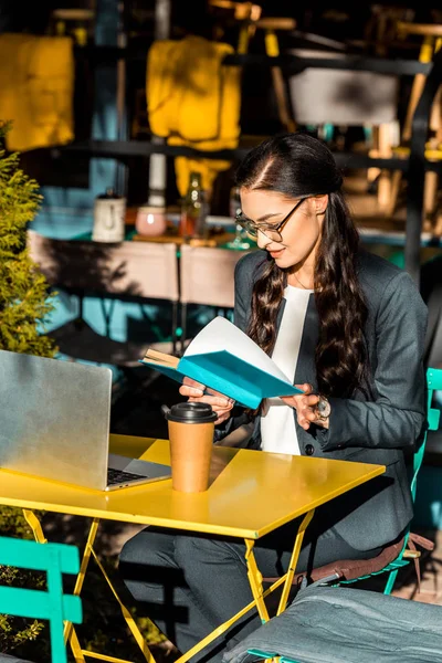 Attractive Freelancer Reading Book Coffee Break Restaurant Terrace Laptop — Free Stock Photo