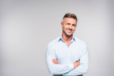 smiling adult man with crossed arms looking at camera clipart