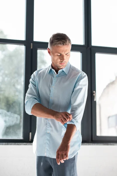 Handsome Adult Man Rolling Sleeves Shirt — Stock Photo, Image