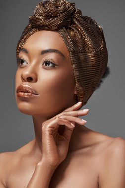 portrait of african american woman with head wrap and bare shoulders looking away isolated on grey clipart