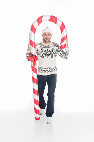 Hombre Joven Suéter Sombrero Santa Claus Con Caramelo Juguete Aislado — Foto de stock gratis