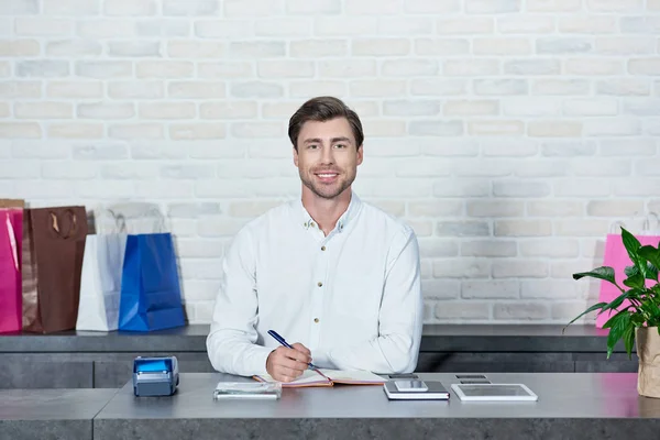 Handsome Young Salesman Smiling Camera While Working Store — Stock Photo, Image