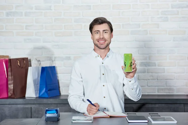 Handsome Male Seller Holding Smartphone Best Shopping Application Smiling Camera — Stock Photo, Image