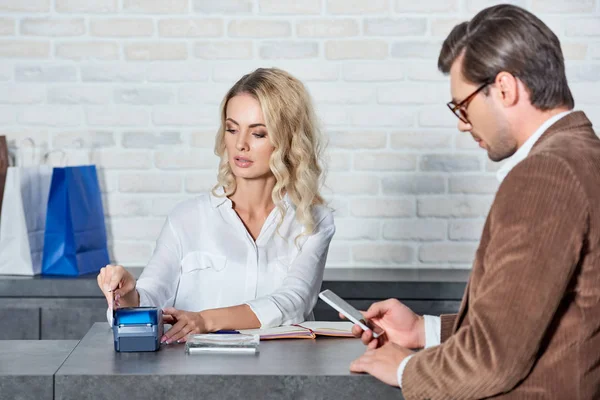 Customer Using Smartphone Seller Working Payment Terminal Credit Card Shop — Free Stock Photo