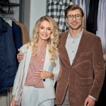 Beautiful stylish couple smiling at camera in store
