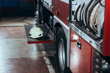close up view of protective helmet on fire truck at fire station clipart