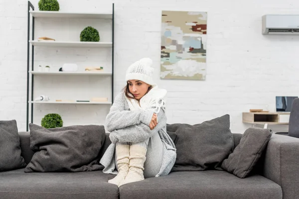 Freezed Young Woman Warm Clothes Sitting Couch Home Looking Away — Stock Photo, Image