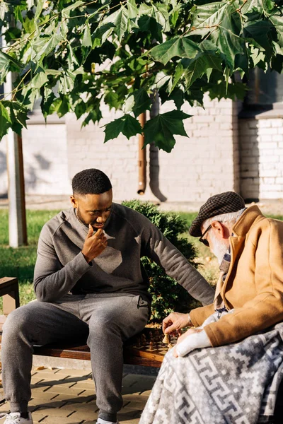 Anciano Joven Afroamericano Cuidador Jugando Ajedrez Juntos Calle — Foto de stock gratis