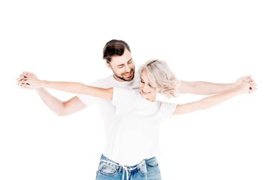 Wonderful couple holding broudly outstreched hands isolated on white clipart