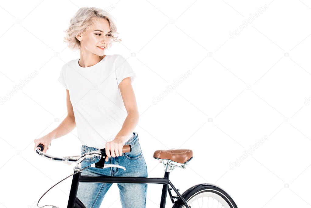 Wonderful blonde young adult woman riding bicycle isolated on white