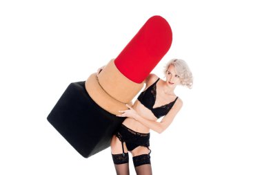 Fantastic young adult woman in lingerie holding big red lipstick isolated on white clipart