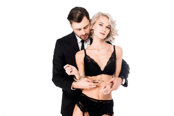 Bonito Homem Traje Preto Algemado Bela Mulher Lingerie Isolada Branco — Fotografia de Stock