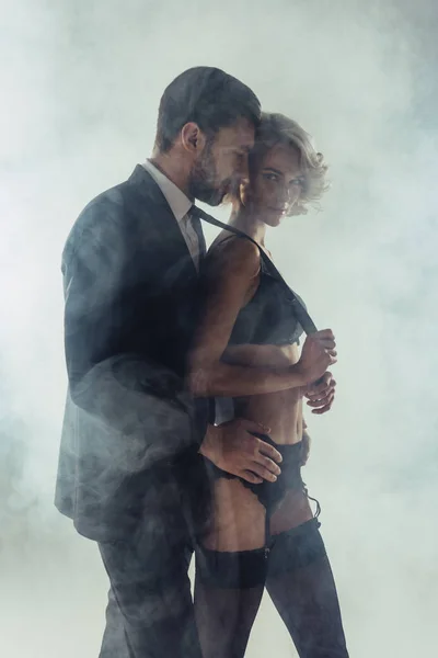 Man Hugging Blonde Wonderful Woman Lingerie While She Pulling Him — Stock Photo, Image