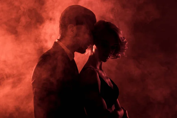 Sensual Man Embracing Passionate Woman Smoke Red Background — Stock Photo, Image
