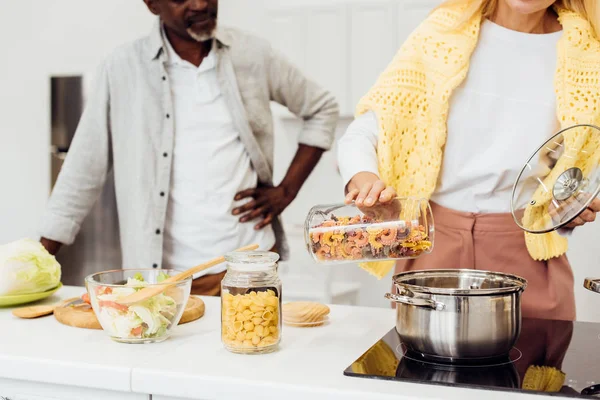 裁剪视图的女人站在非洲裔美国男子和烹饪面食 — 免费的图库照片