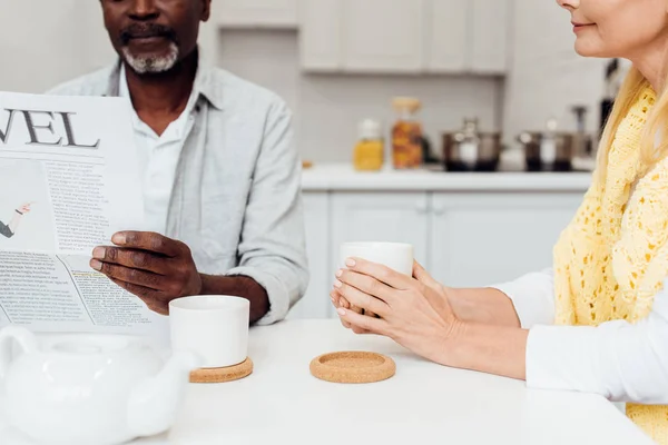 Close African American Man Reading Newspaper While Woman Drinking Tea — Stock Photo, Image