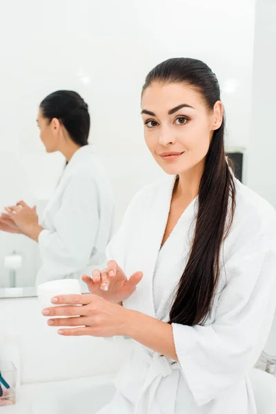 Beautiful Woman White Bathrobe Applying Body Cream — Free Stock Photo